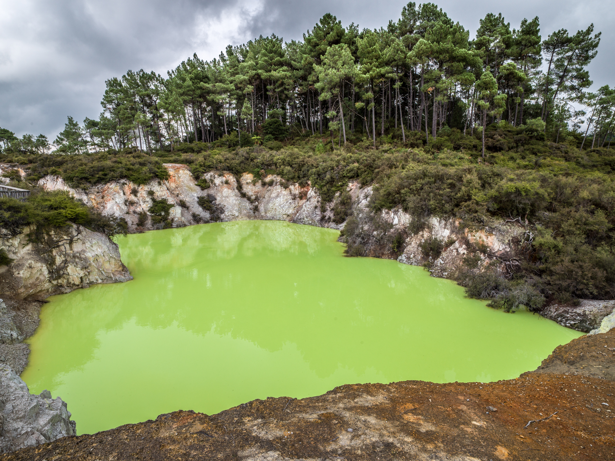   Waiotaupu’s “Devil Bath,” New Zealand  - The green color of this geothermal pool is caused by sulphur deposits along with other minerals fed by the nearby Champagne Pool. Waiotapu is protected as a reserve, but has a long history of tourism and sin