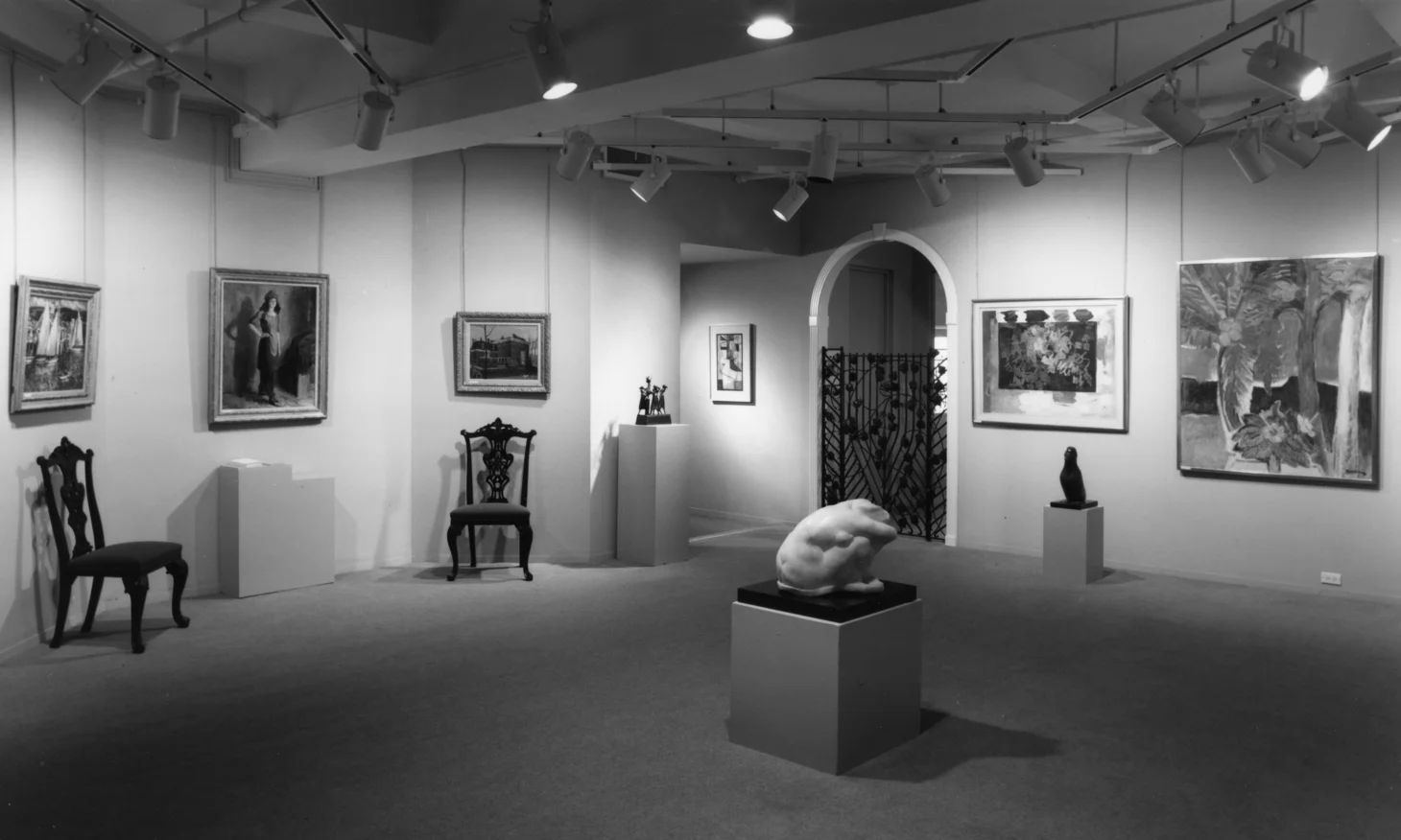 Image of 724 Fifth Avenue - paintings hanging on walls with three sculptures in center