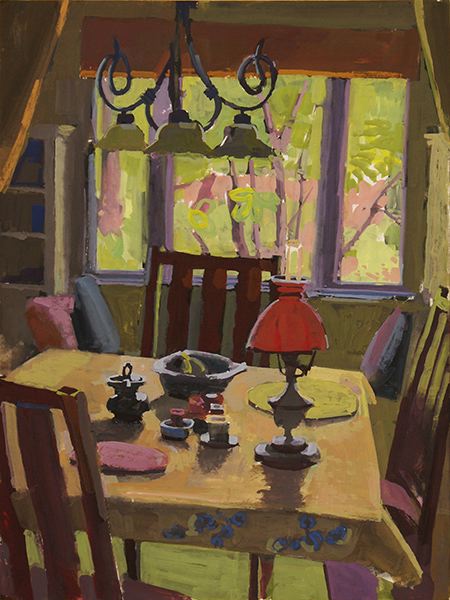 Table with large window and lamp with bright red shade