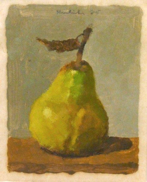 Green/yellow pear on brown surface with blue background