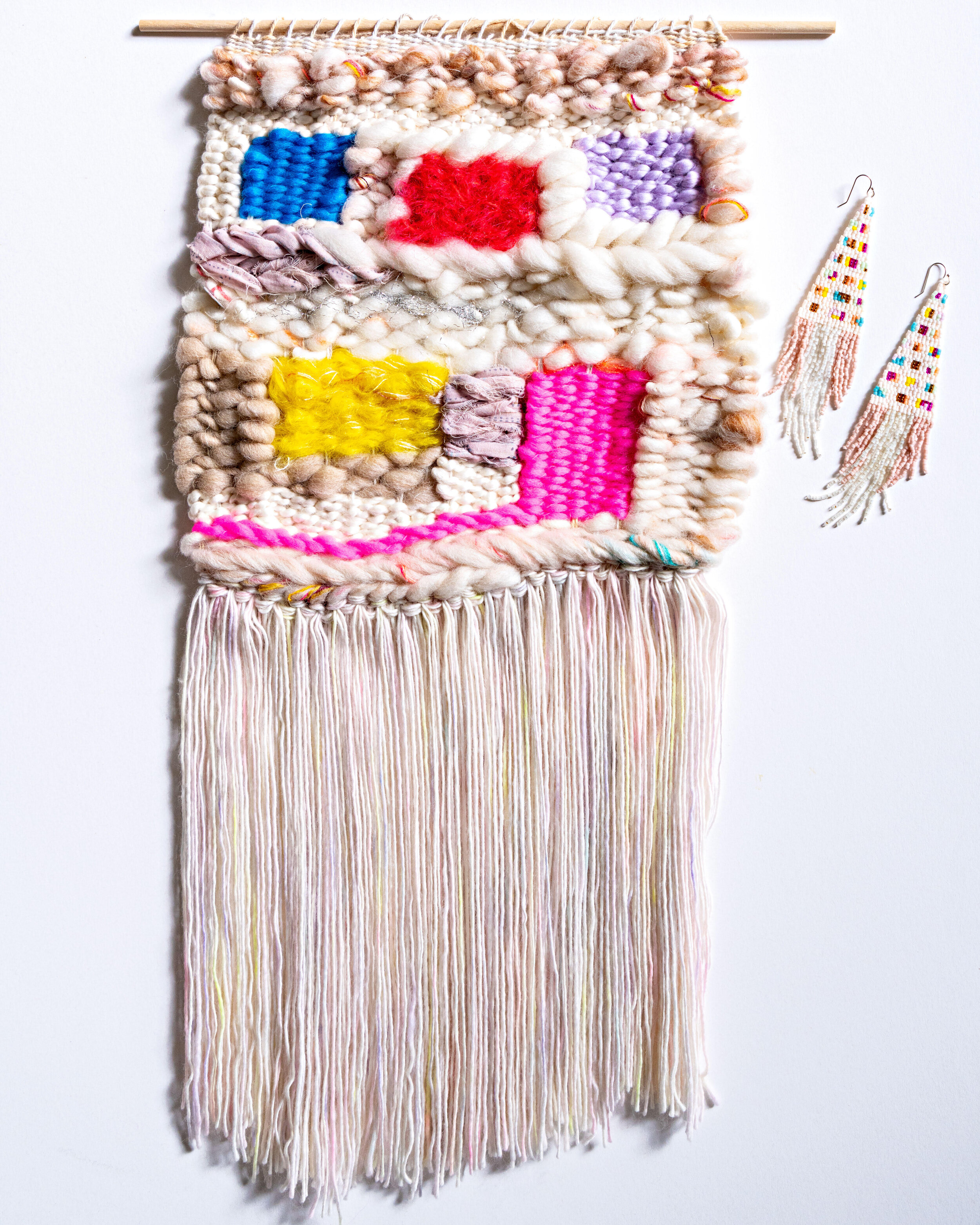 wool woven tapestry in white with purple, red, pink, blue, and yellow square windows.  Beaded earrings to match