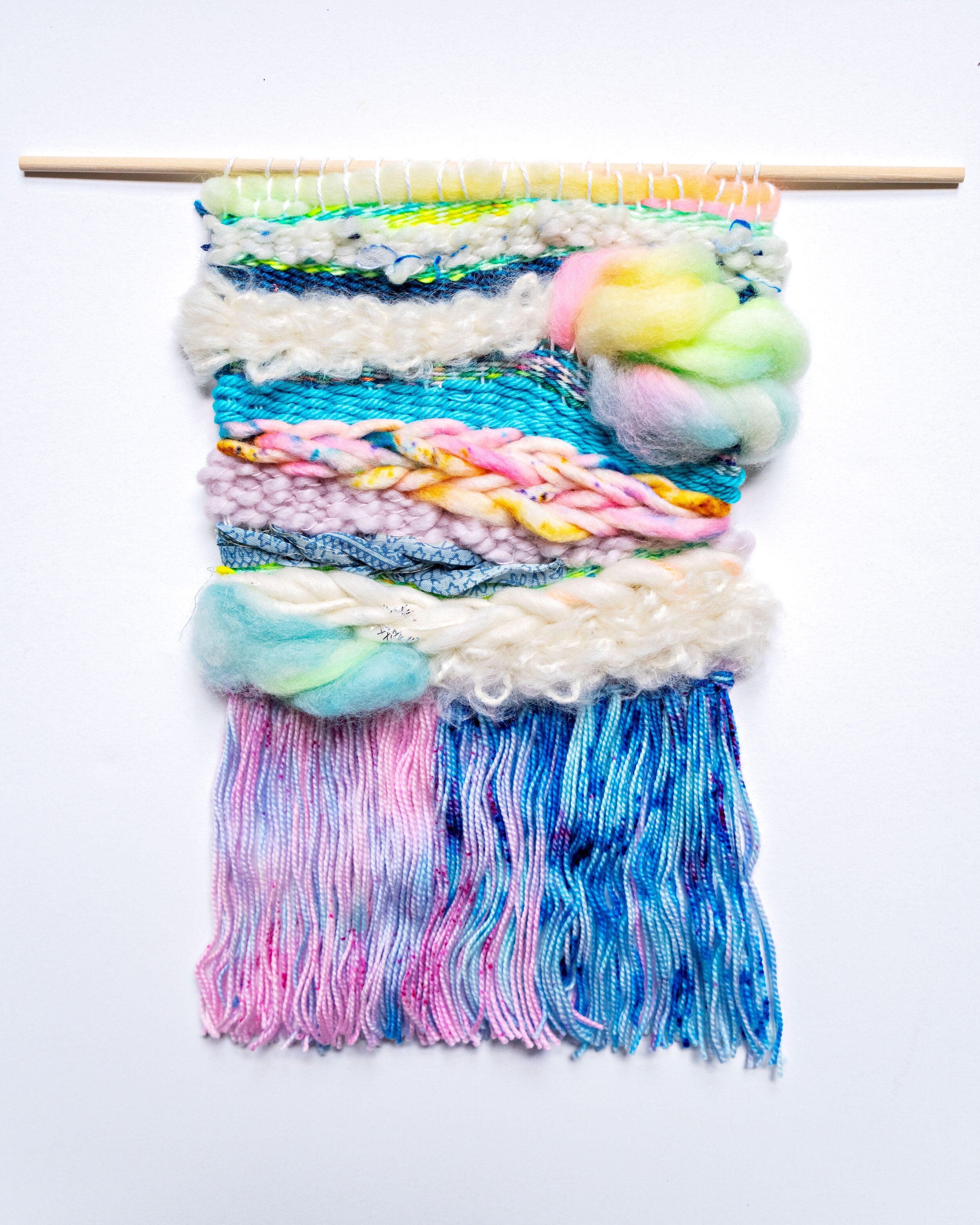 wool and cotton woven tapestry in pastel blues, pinks and greens