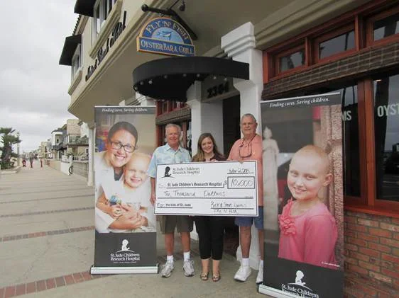 Owners Rick and Steve Loomis w ith Shannon O'Nale of St. Jude Children's Research Hospital