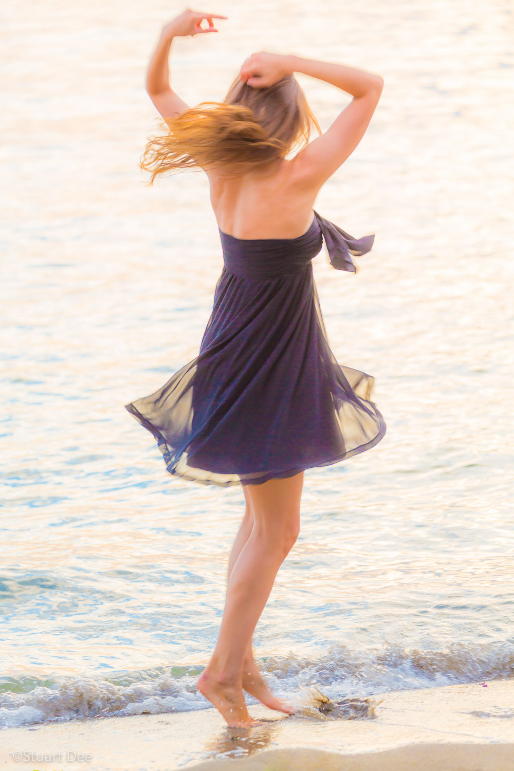  Young woman frolicking by the beach 