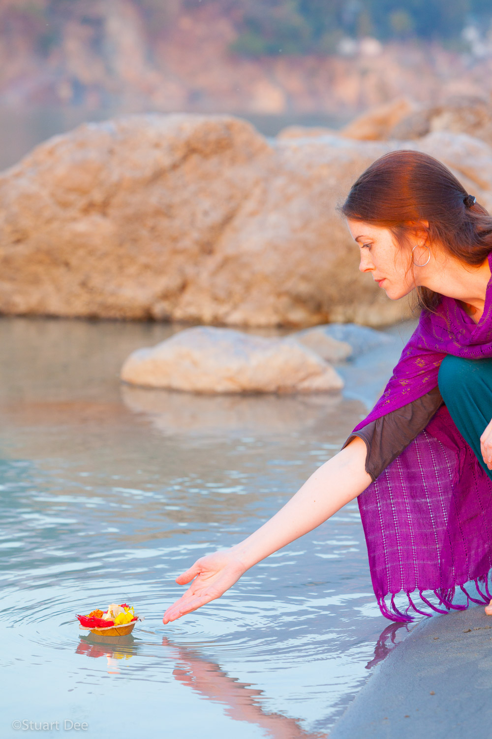  Woman releasing offering onto the holy RIver Ganges, Rishikesh, Uttarakhand, India.
Rishikesh is located in the foothills of the  Himalayas in northern India and attracts thousands of pilgrims and visitors annually.  It is a vegetarian and alcohol-f