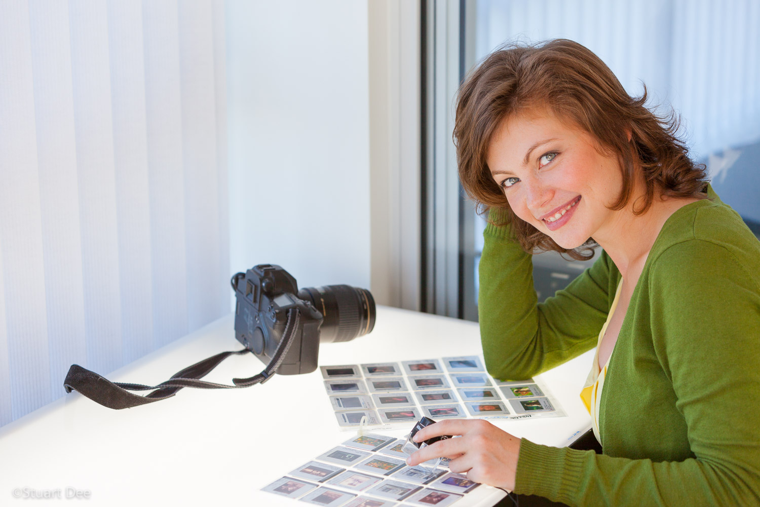  Photographer editing slides at a light table 