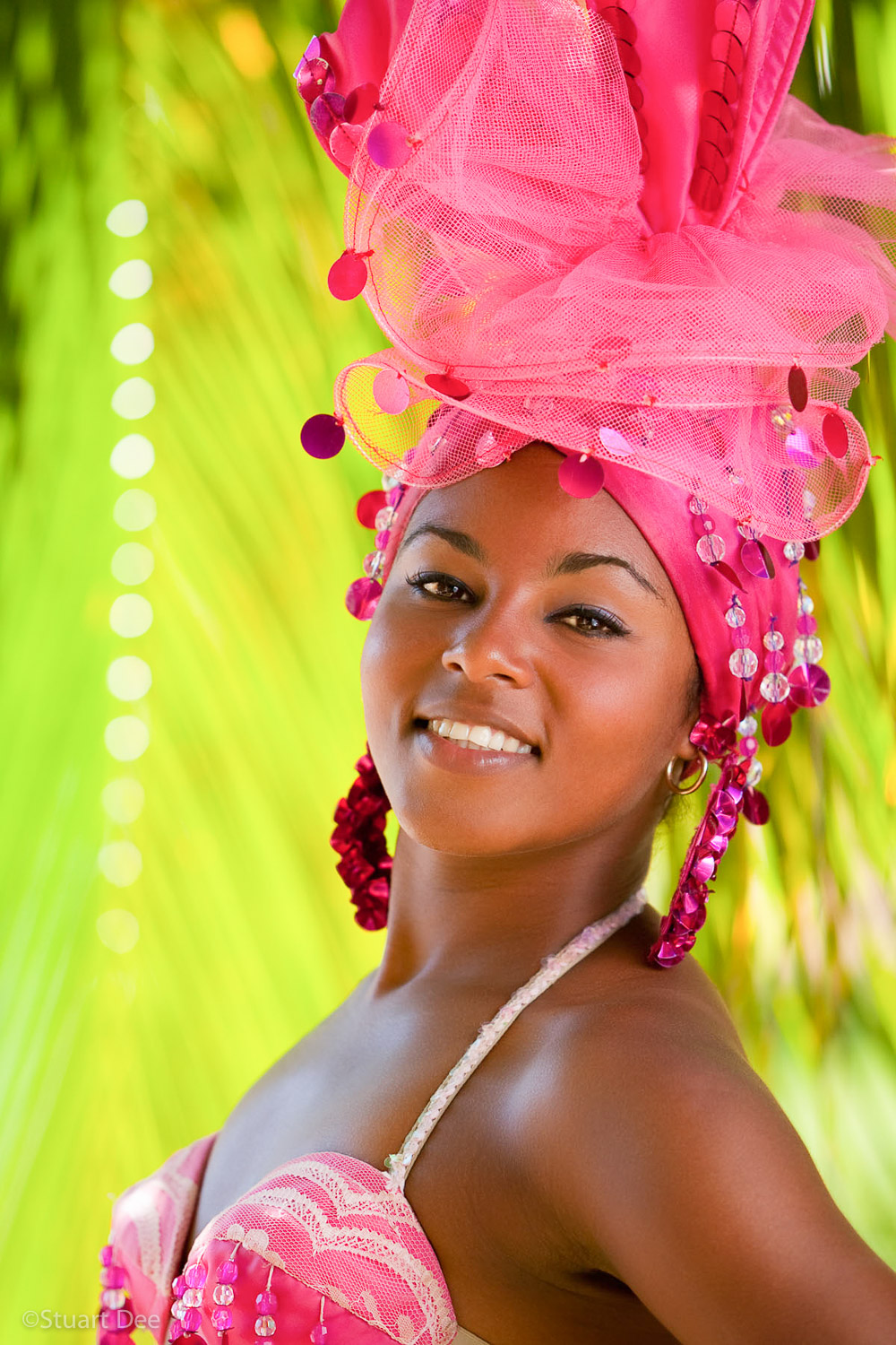 Cuban dancer in costume outdoors, with palm tree behind her, Trinidad, Cuba