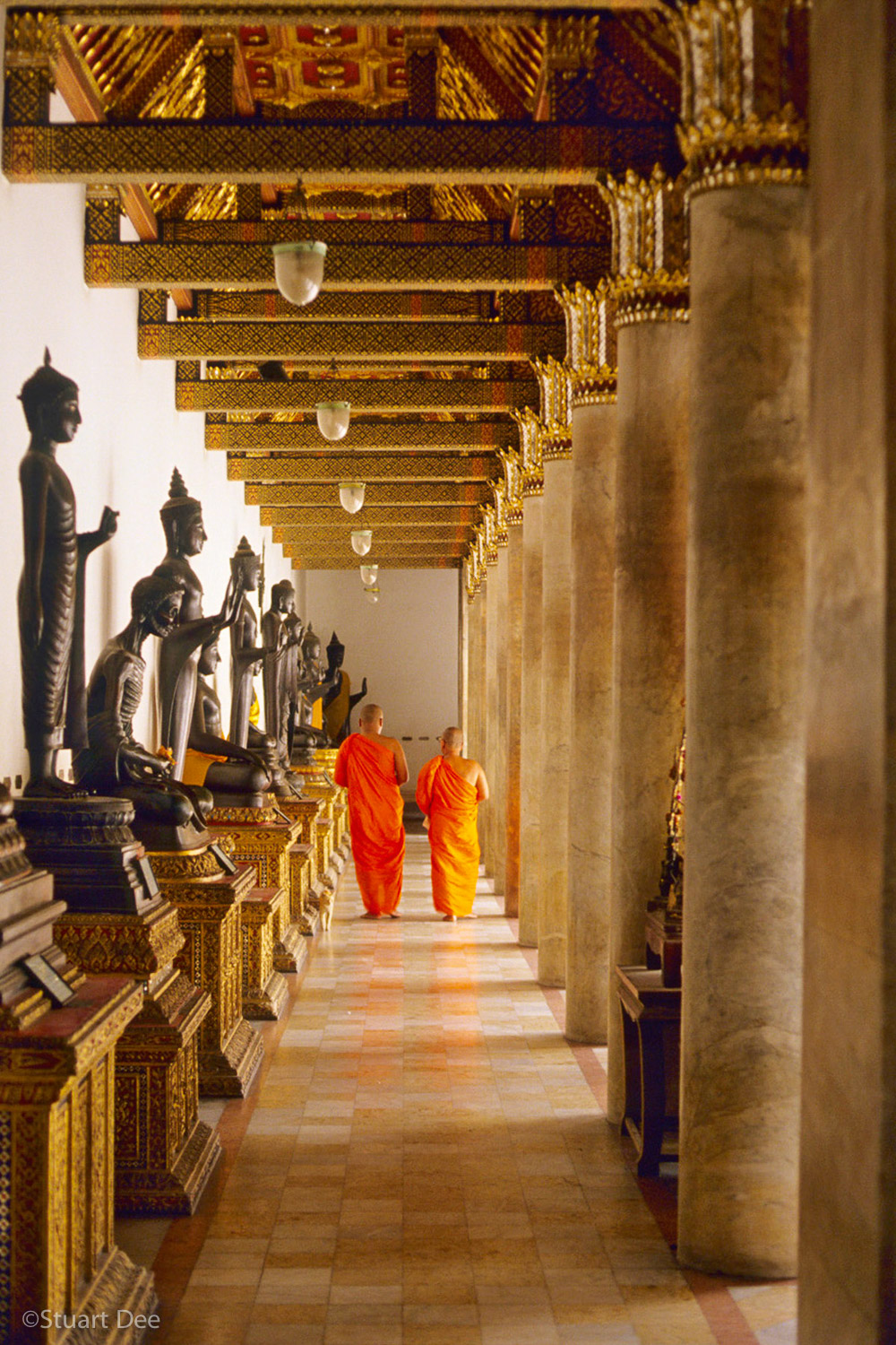  Two Buddhist monks walking down hallway, Marble  Temple,  Bangkok, Thailand 