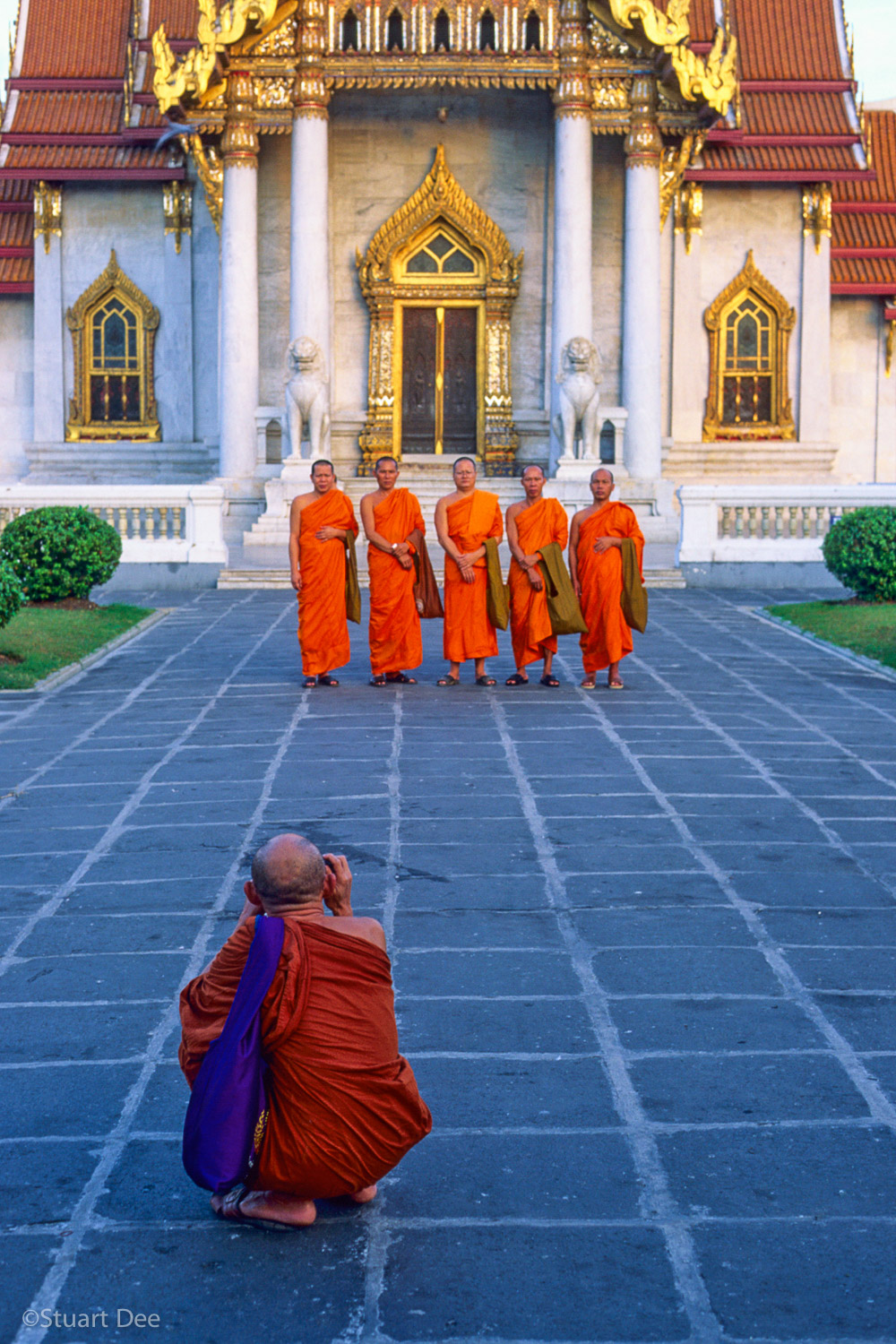Monk talking picture of other monks, Marble Temple, Wat Benchamabophit, Bangkok, Thailand