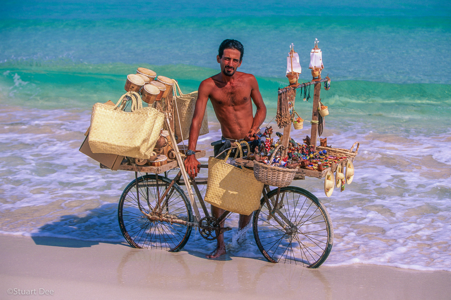 Beach vendor selling souvenirs, with his bicycle, Varadero, Cuba  
R 