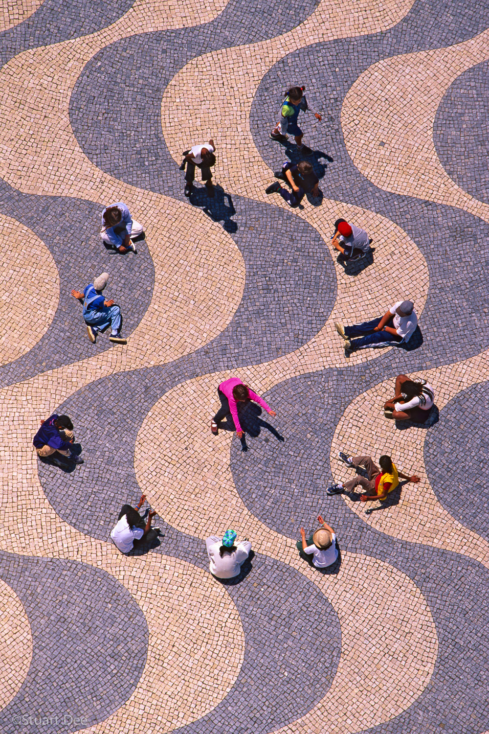  Multi-ethnic schoolchildren in a circle playing a game. Aerial view, with wave pattern designed by Burle Marx, Belem, Lisbon, Portugal 