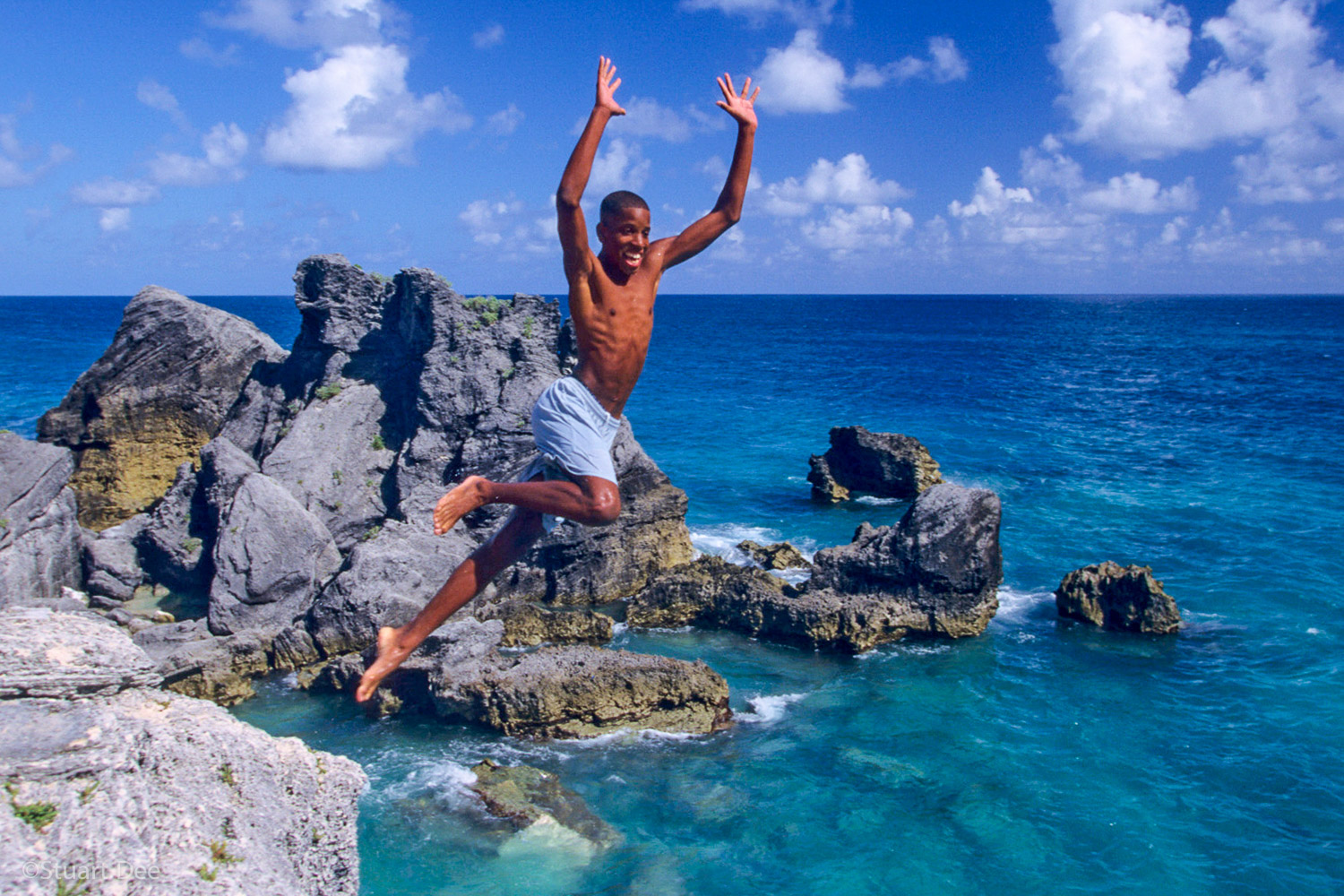  Boy jumping off cliff, Bermuda  R 