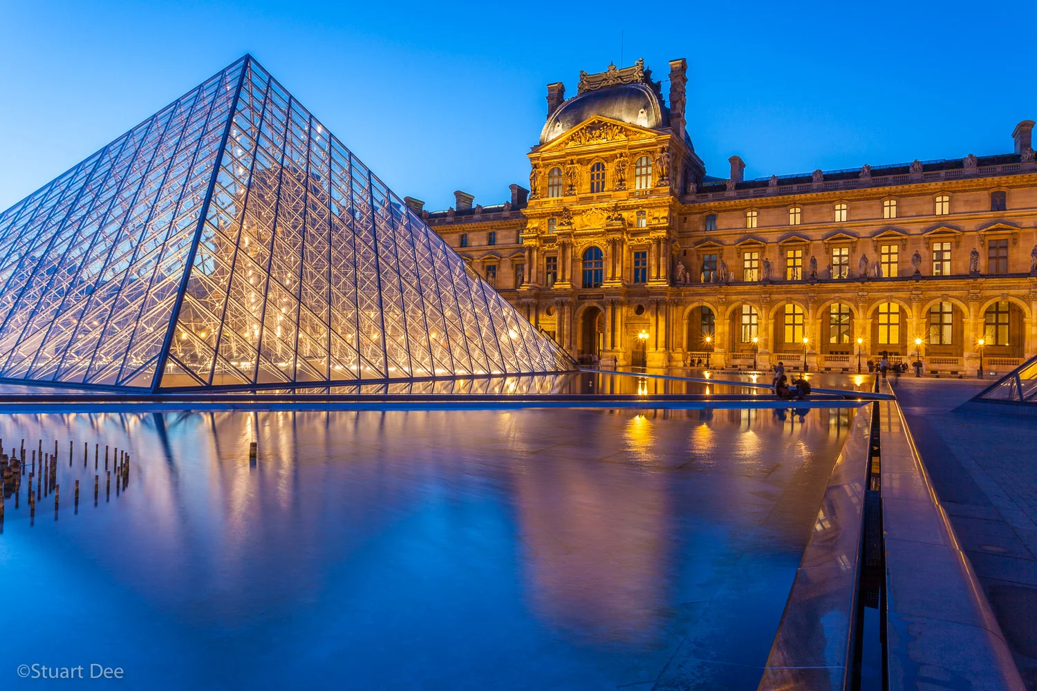 Louvre Museum and Pyramid at twilight/night, Paris, France. The Louvre is one of the most important and is the most visited art museum in the world.