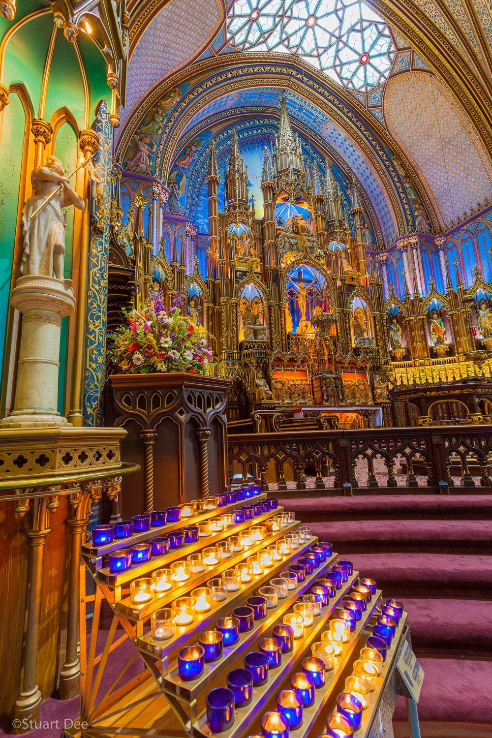  Votive candles and altar, Notre-Dame Basilica, Old Montreal, Montreal, Quebec, Canada. The church is one of the best known  landmarks and symbols of Montreal. 