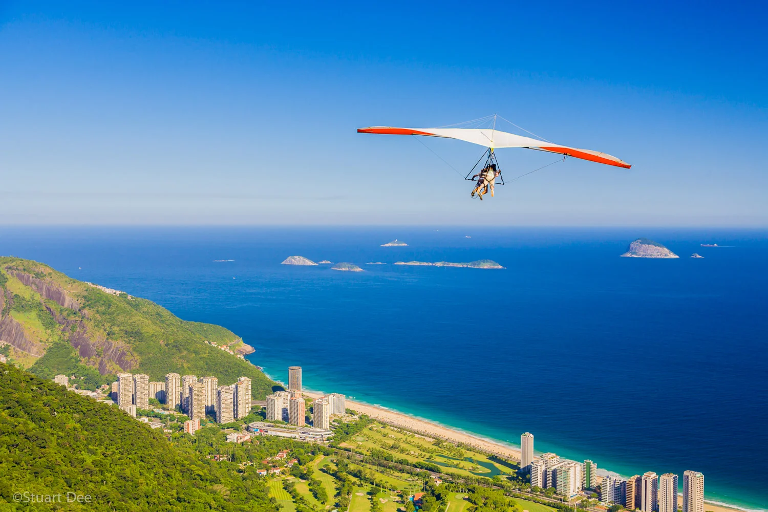 Hang gliders taking off from the Pedra Bonita Ramp and flying over the Tijuca Forest, Gavea Golf Course, and Sao Conrado, Rio de Janeiro, Brazil