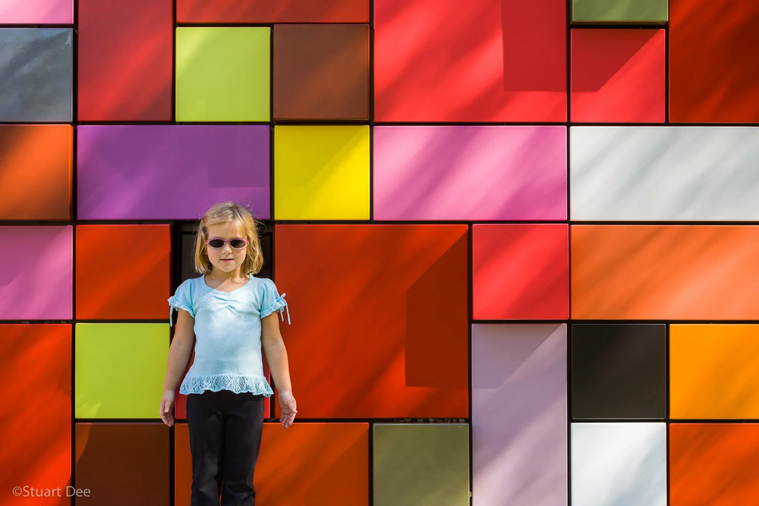 Mottled light on colorful facade, Discovery Green Park, Houston, Texas, USA. The park is the only eco-park in Houston. Houston is the fourth largest city in the USA.