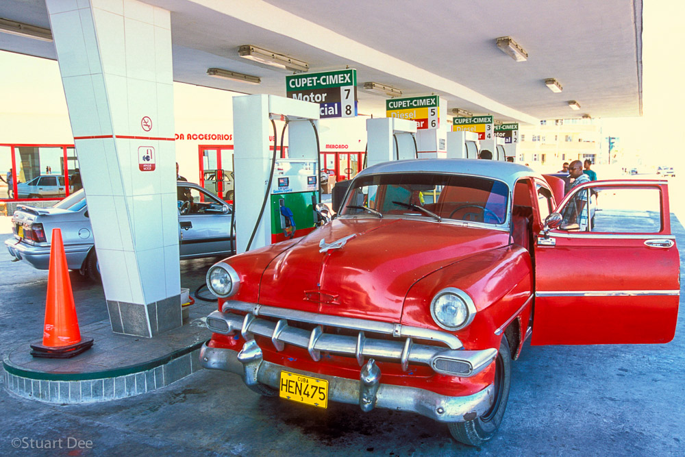 Vintage American car at gas station, Havana, Cuba