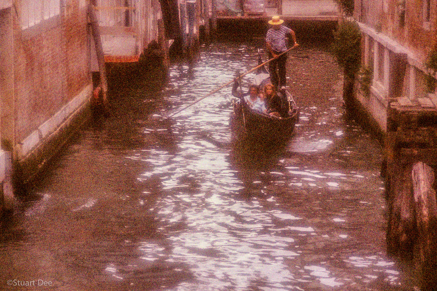  Romantic couple in gondola, Venice, Italy. Grainy, pointiliistic effect, soft focus style. 