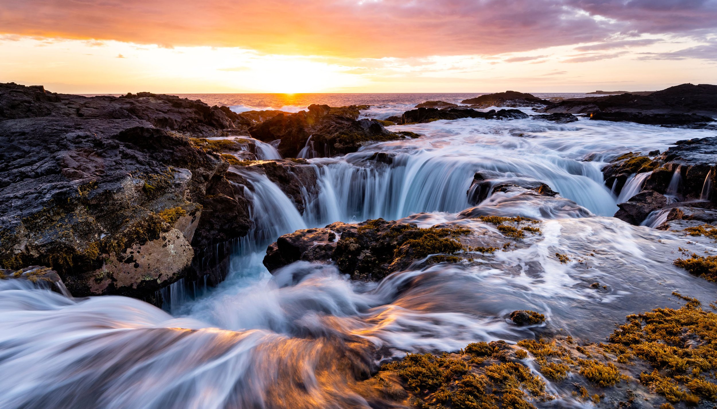  Landscape: Waves crash on the rocky coastline at sunset near Kona, Big Island, Hawaii 