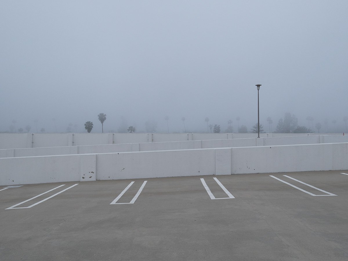  Deck Studies explores the elevated, empty top decks of urban parking structures across Pasadena, California. Positioned above the street level, these utilitarian concrete spaces serve as quiet vantage points and visual sanctuaries—letting the adjace