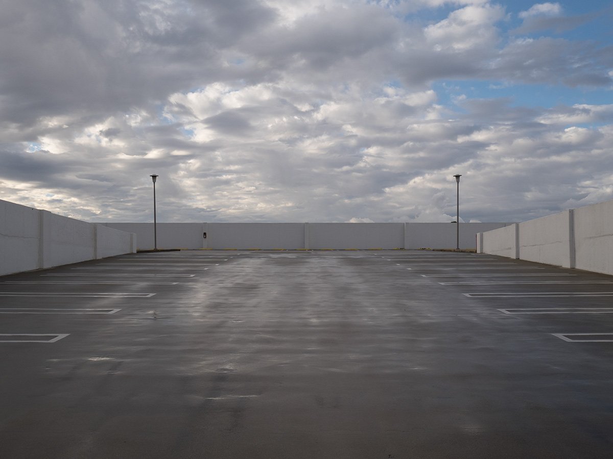  Deck Studies explores the elevated, empty top decks of urban parking structures across Pasadena, California. Positioned above the street level, these utilitarian concrete spaces serve as quiet vantage points and visual sanctuaries—letting the adjace