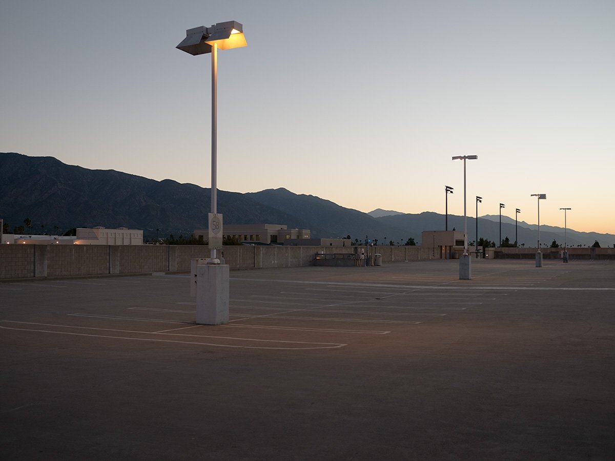  Deck Studies explores the elevated, empty top decks of urban parking structures across Pasadena, California. Positioned above the street level, these utilitarian concrete spaces serve as quiet vantage points and visual sanctuaries—letting the adjace