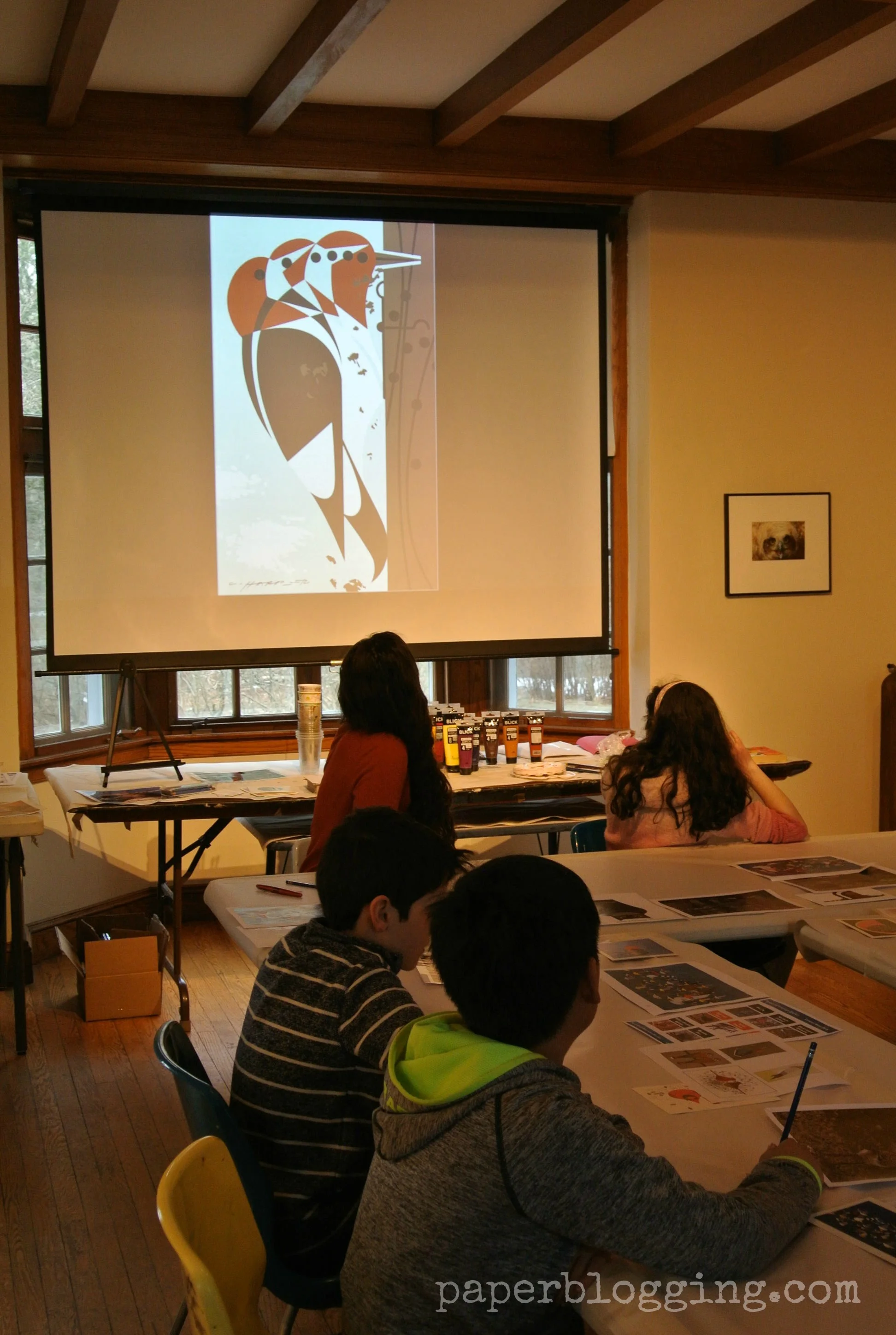 Time to make some art! Getting ready to paint in the style of Charlie Harper. Notice the tables are covered in paper so practice sketches can be done on the table. Fun! Museum of American Bird Art.