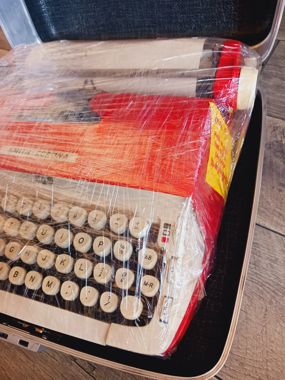  Typewriter wrapped in several layers of clingfilm in each direction 