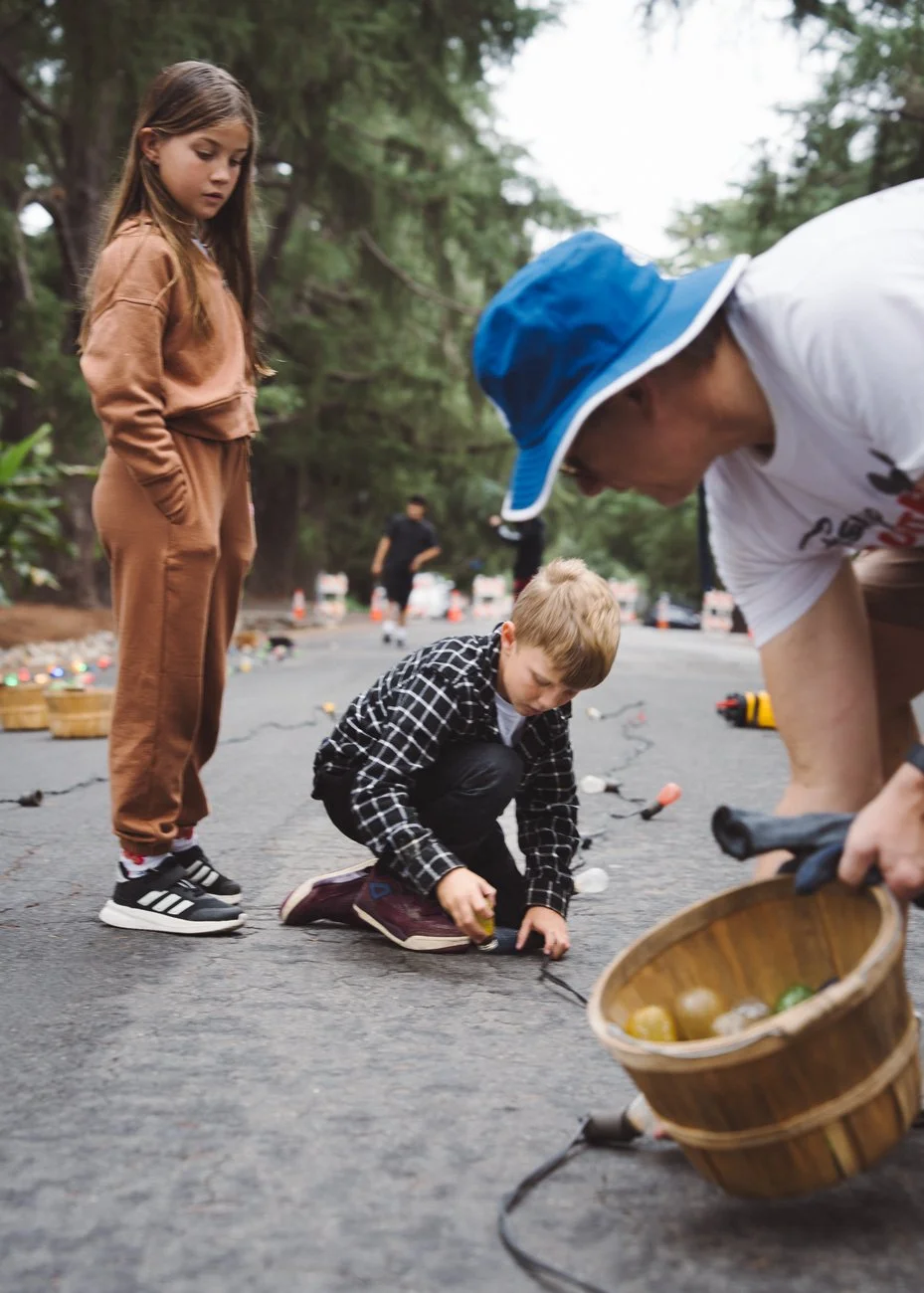 Volunteers string lights along the lane in September.