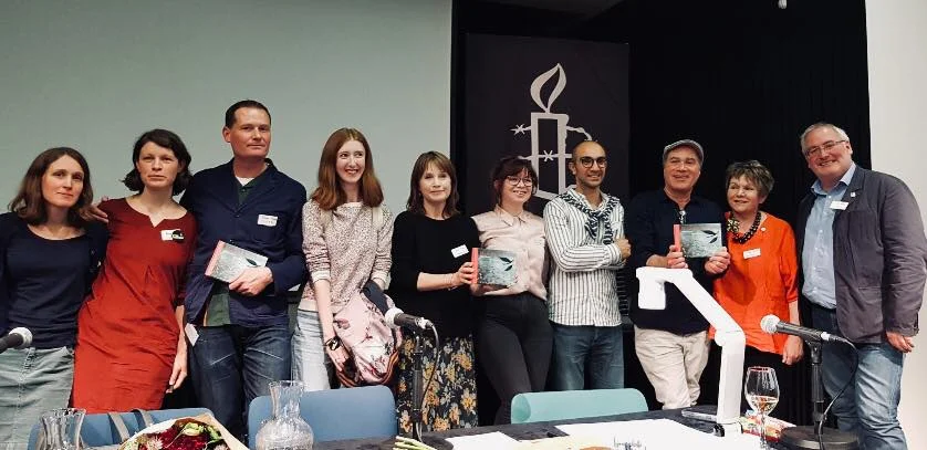 The panel and collaborators smiling for the camera