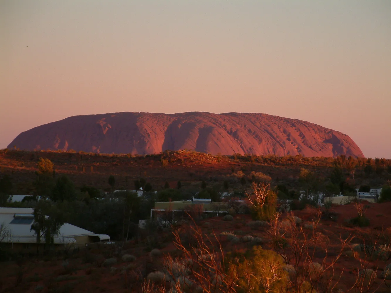 Uluru at sunset as seen from the hill behind our campsite at Yulara.20.2 kms away
