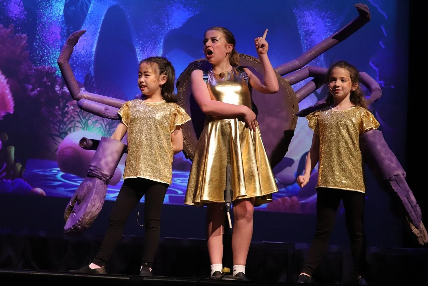 "Youth cast performing Moana Jr on stage at Bedford Youth Performing Company"
