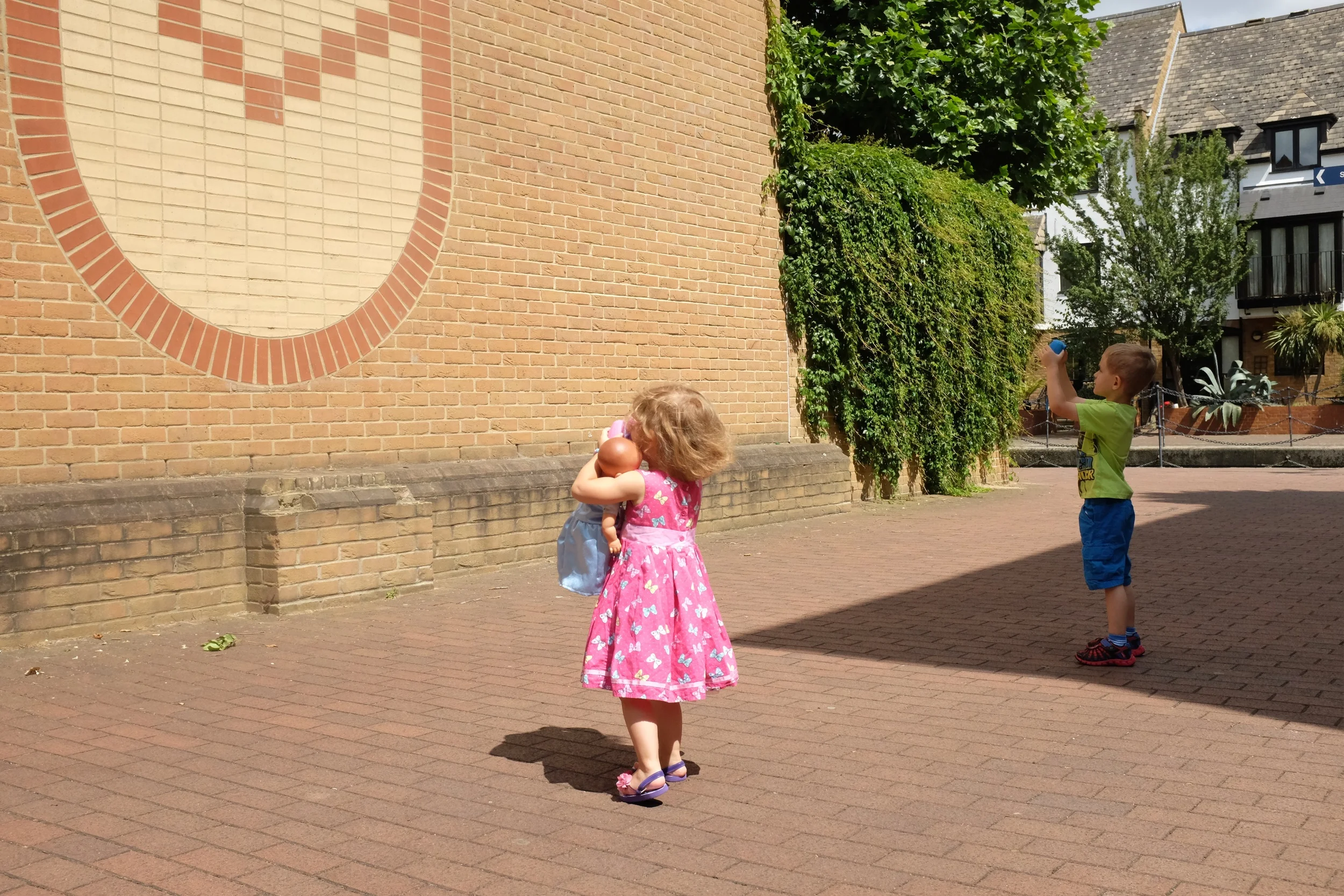 Taking a picture of a patterned wall on our walk