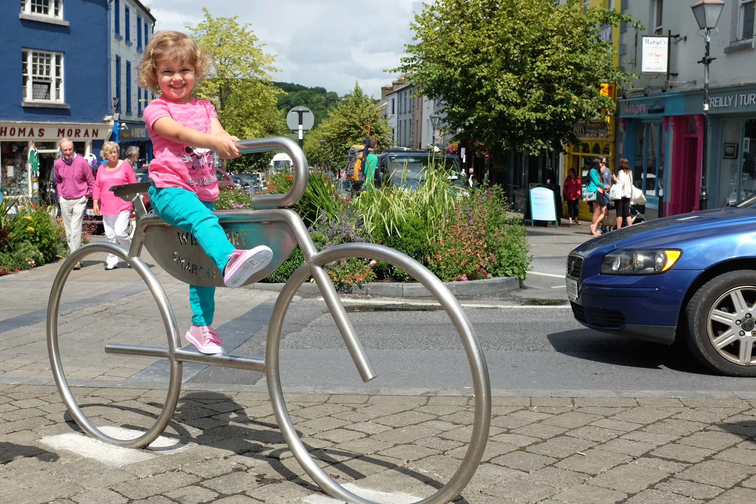Hannah enjoying her "ride" on the metal bicycle