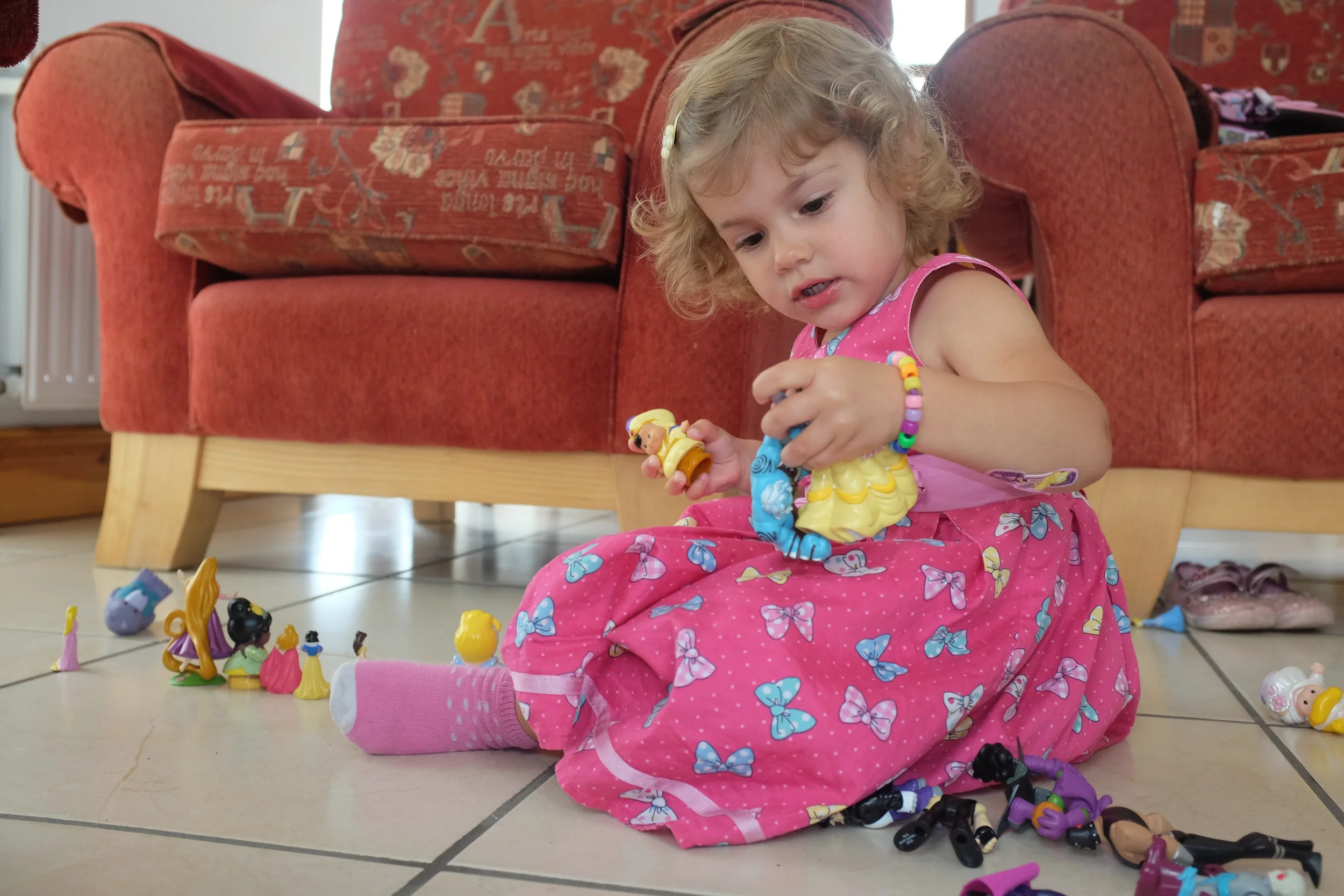Hannah playing with her princesses and Kian's super villains 