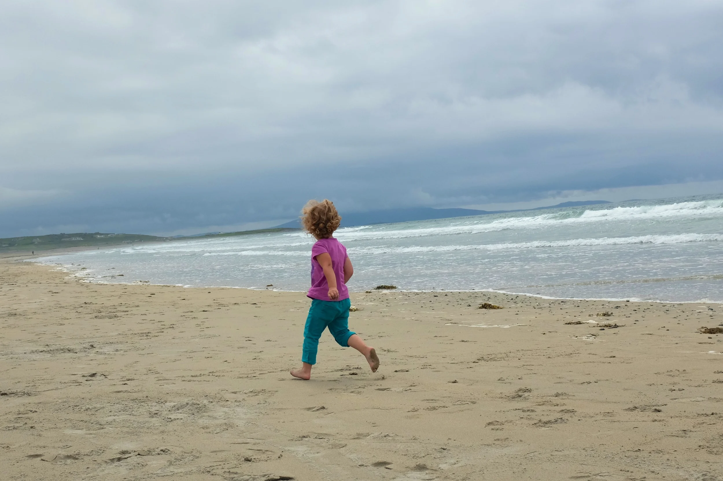 Hannah running away from the waves