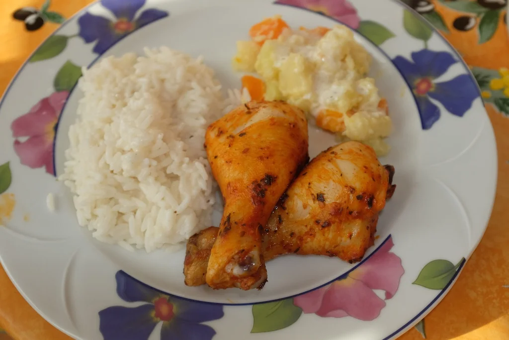 Marinated chicken legs baked in the oven with rice and veggies made in coconut milk
