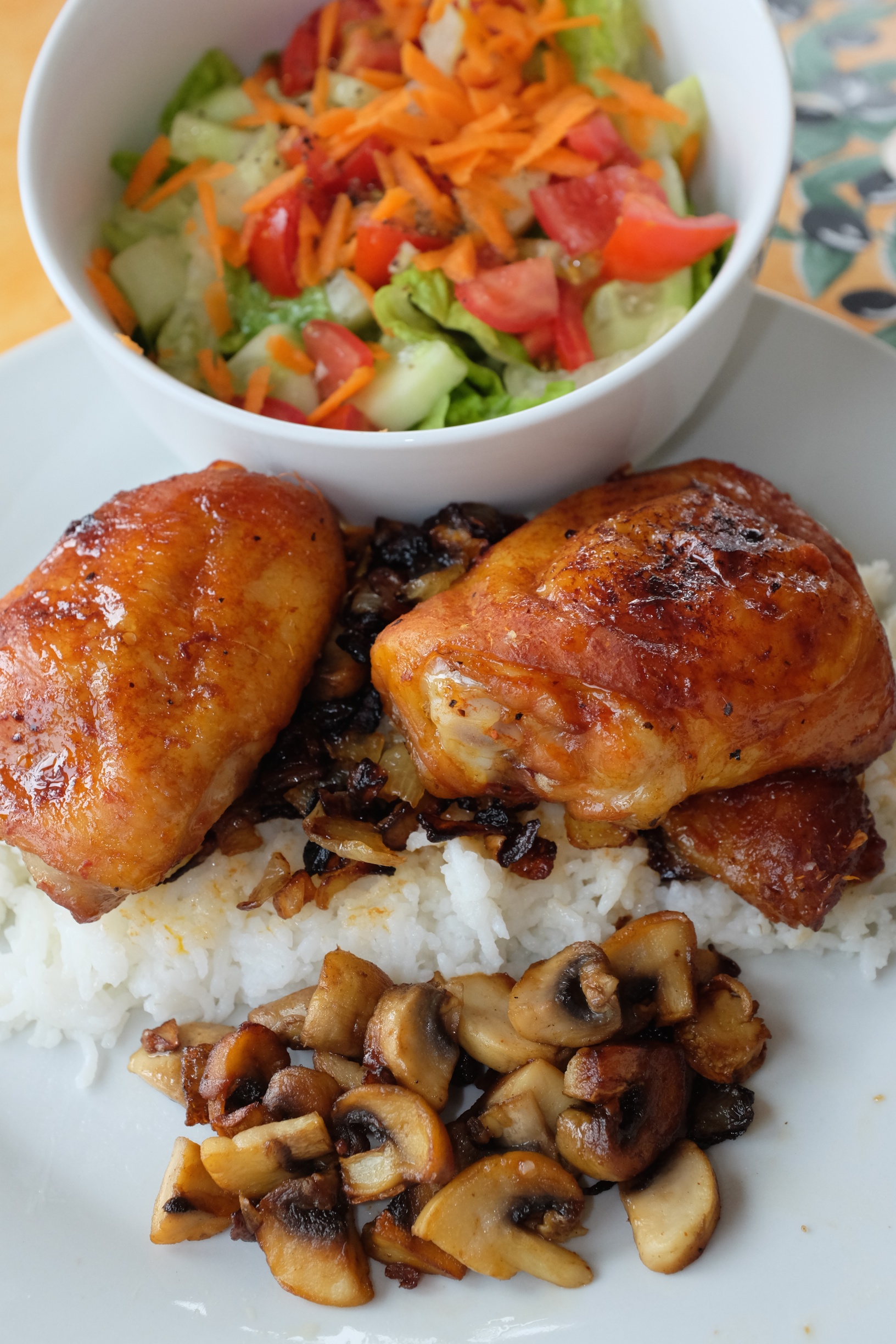 Chicken thighs baked in the oven atop rice with a side of mushrooms + a side salad