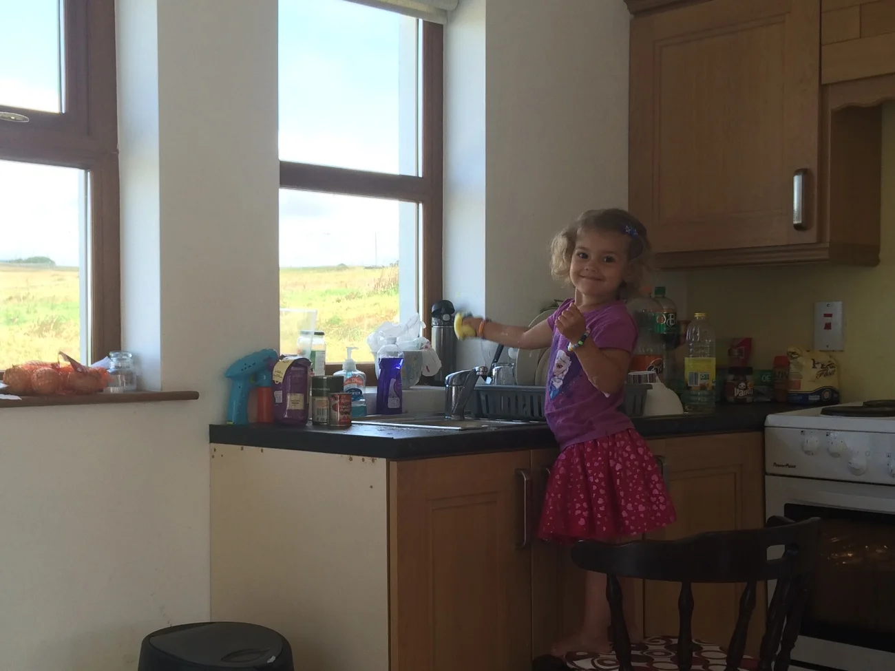 Hannah washing breakfast's dishes