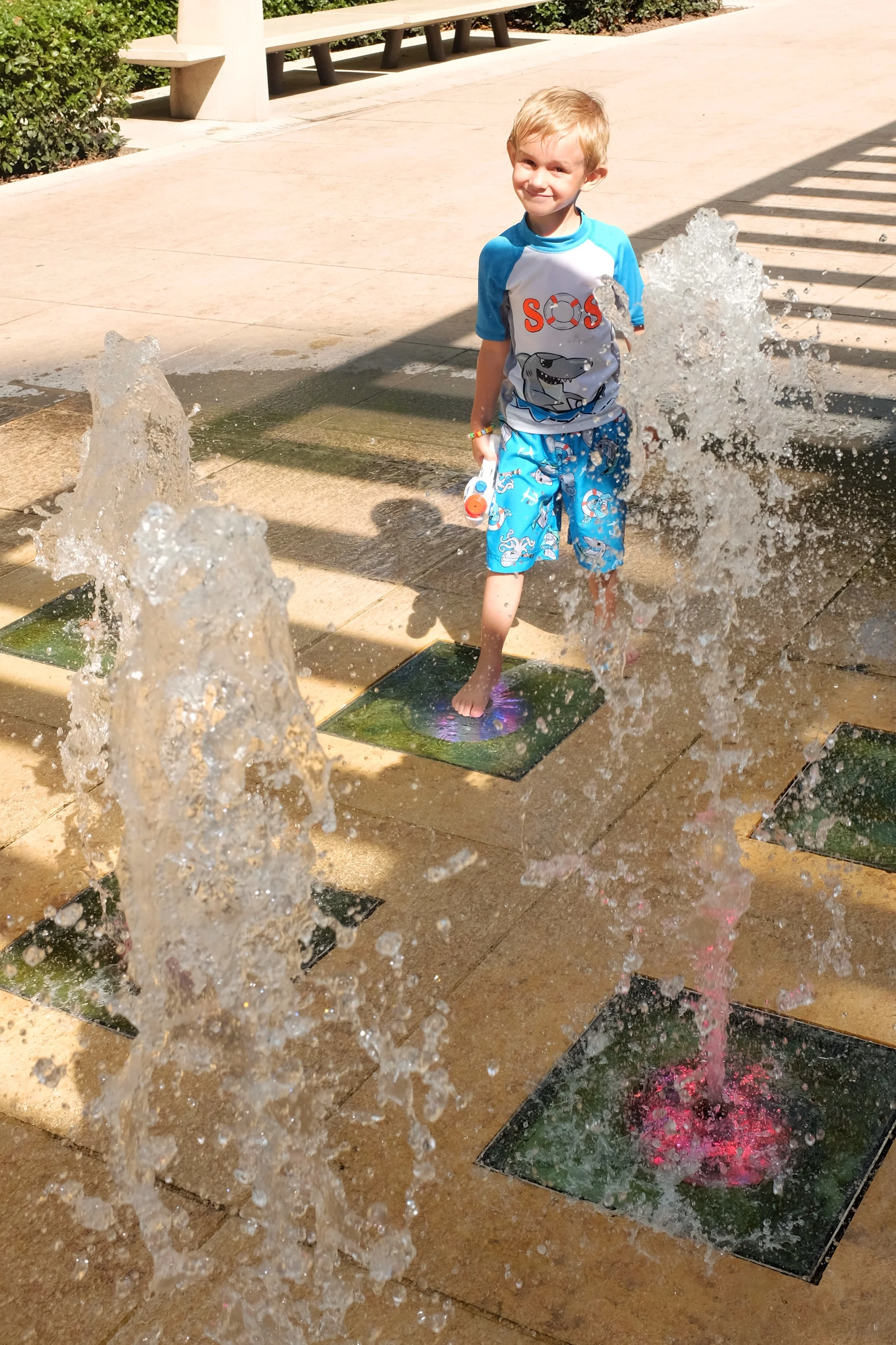 Kian enjoying the cool splash on the hot sunny day