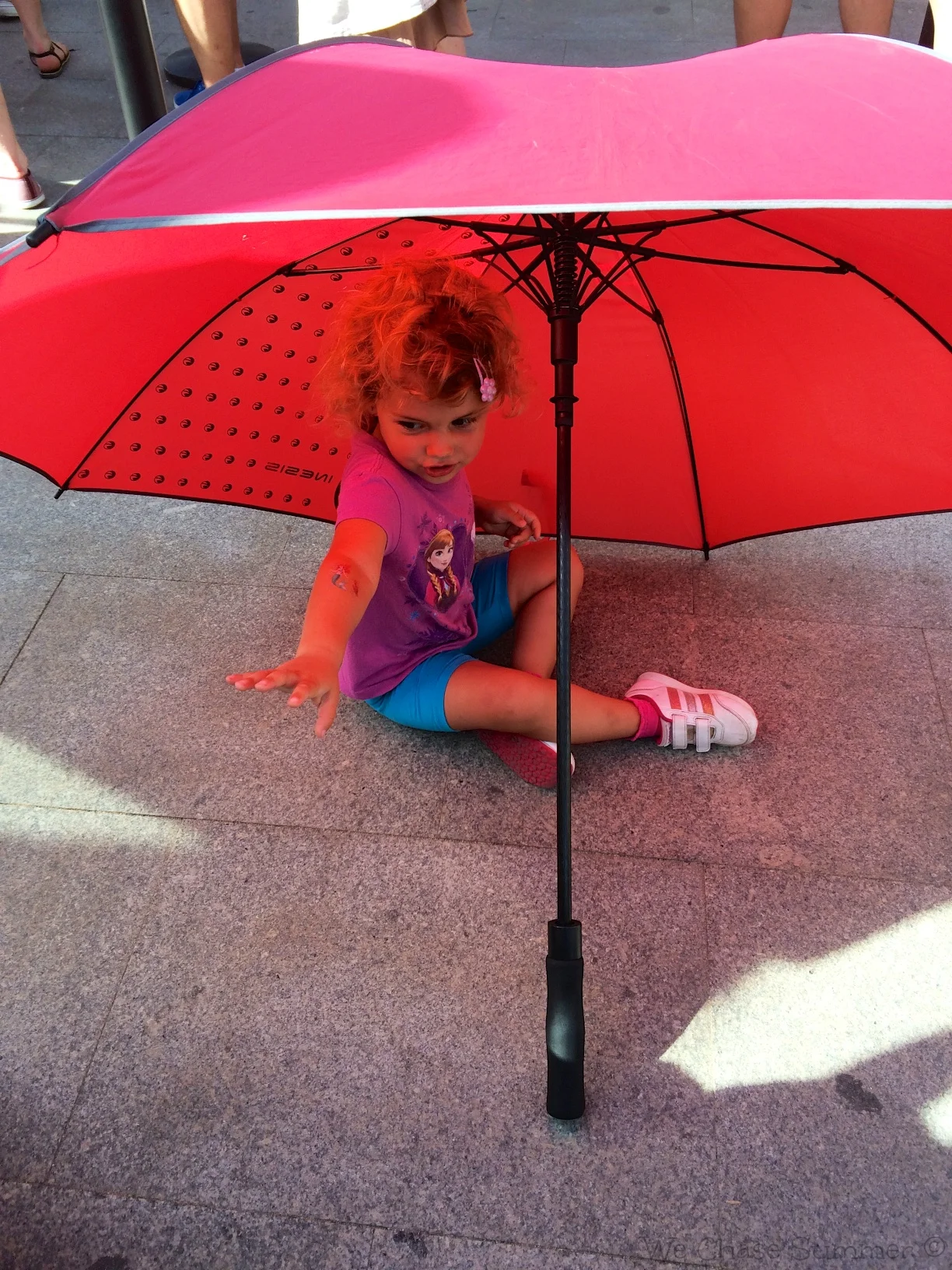 Hannah made a tent out of an umbrella to keep away from the hot sun