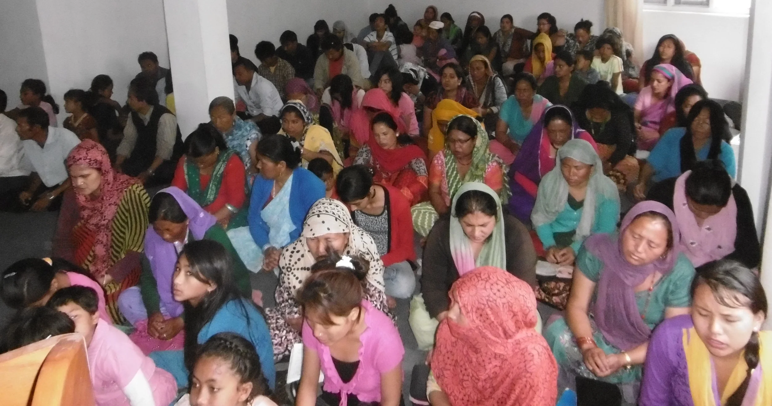Part of Mukunda's congregation at worship. He started with nothing but has 200 worshippers now.