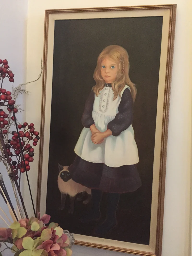 Painting of Kellas and her first cat by her mother, Helen