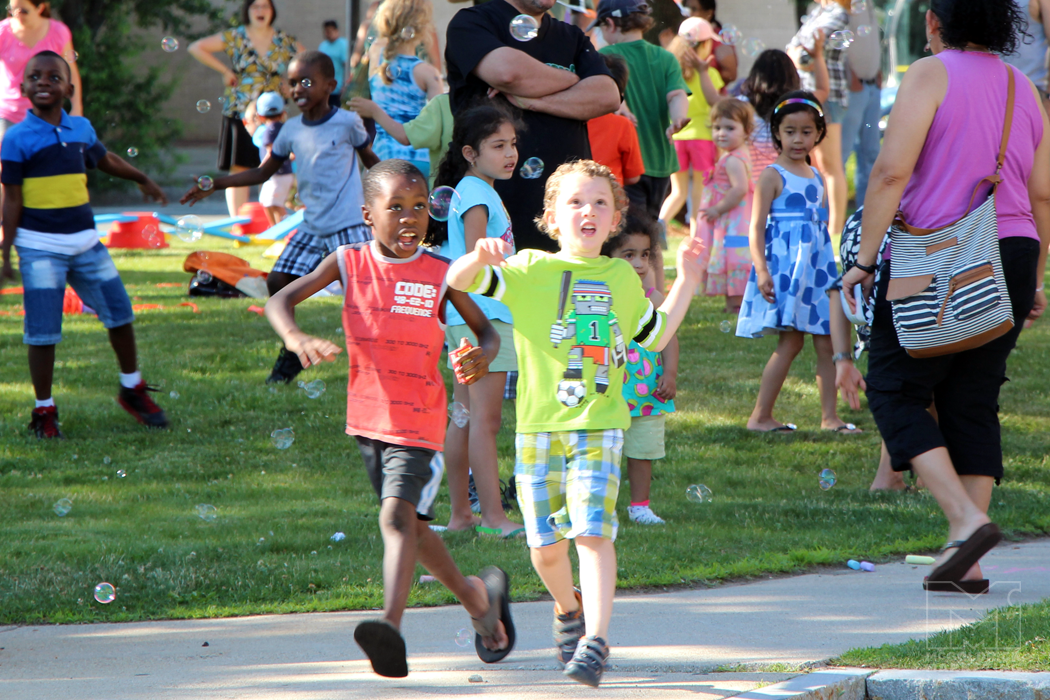Boys chasing bubbles