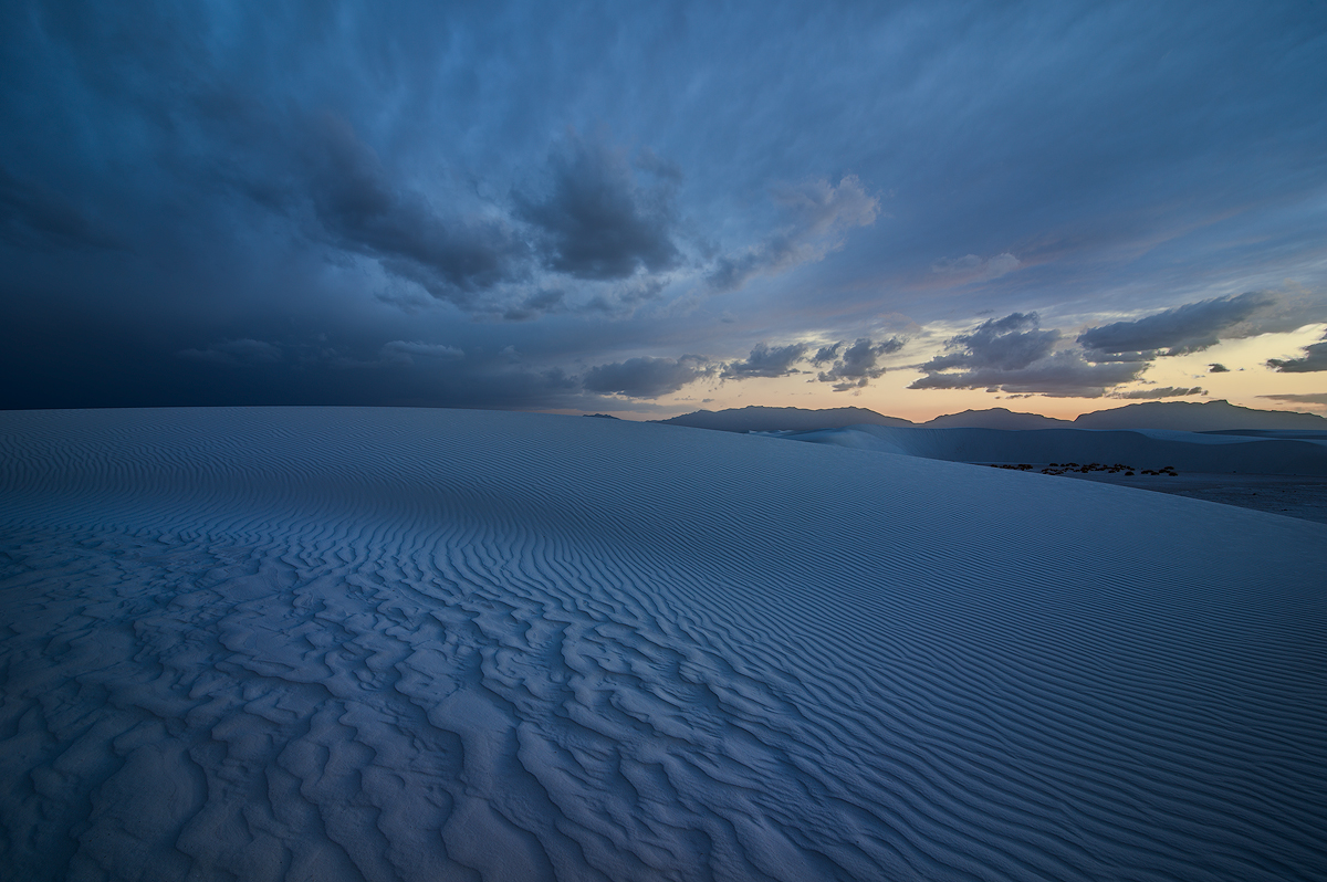 Mysteriously shaped patterns merge into the ever present ripples and lead the eye towards the final light of the day.