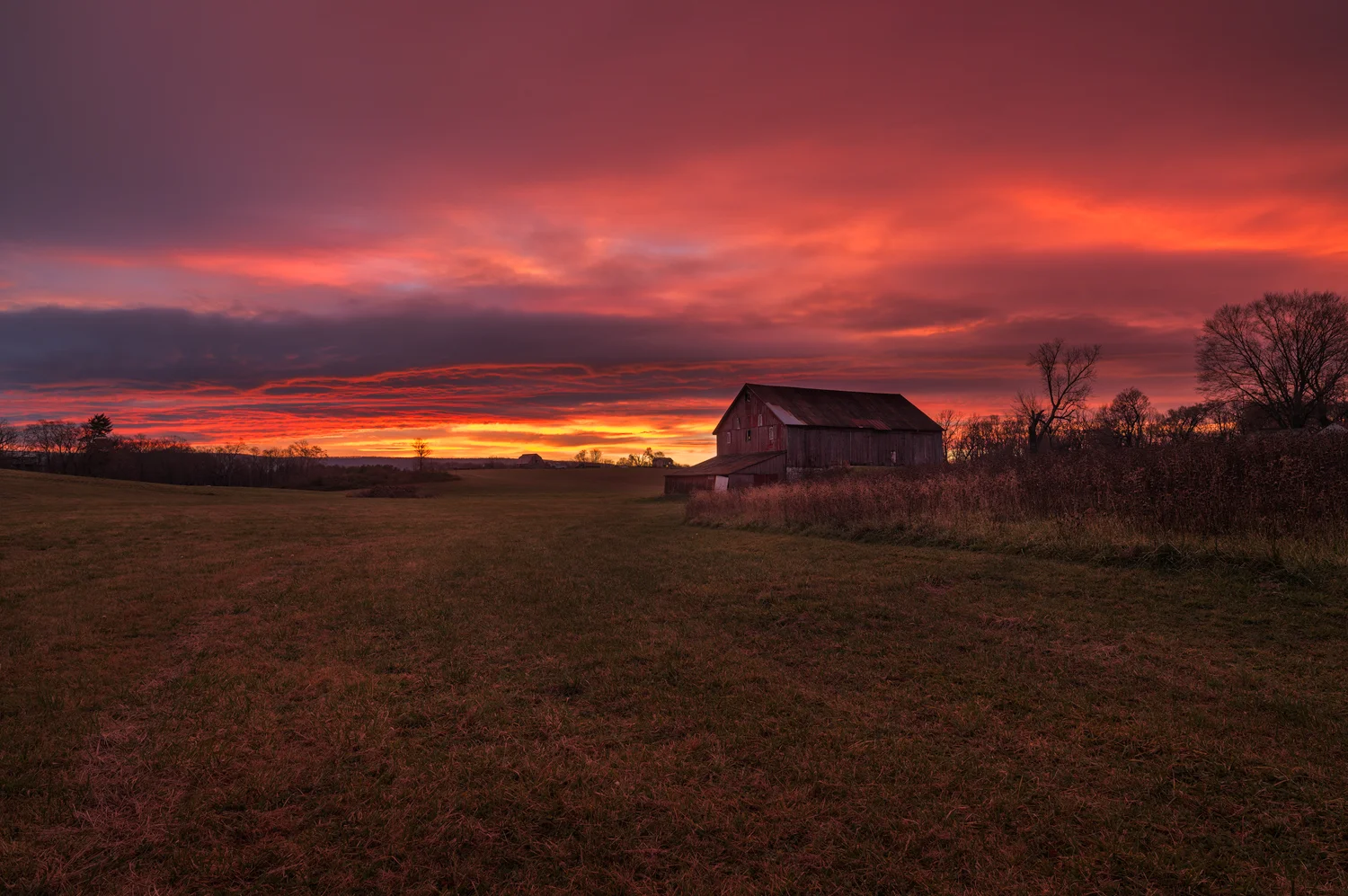 The Sky Explodes in the Colors of Sunrise over The Red Barn.