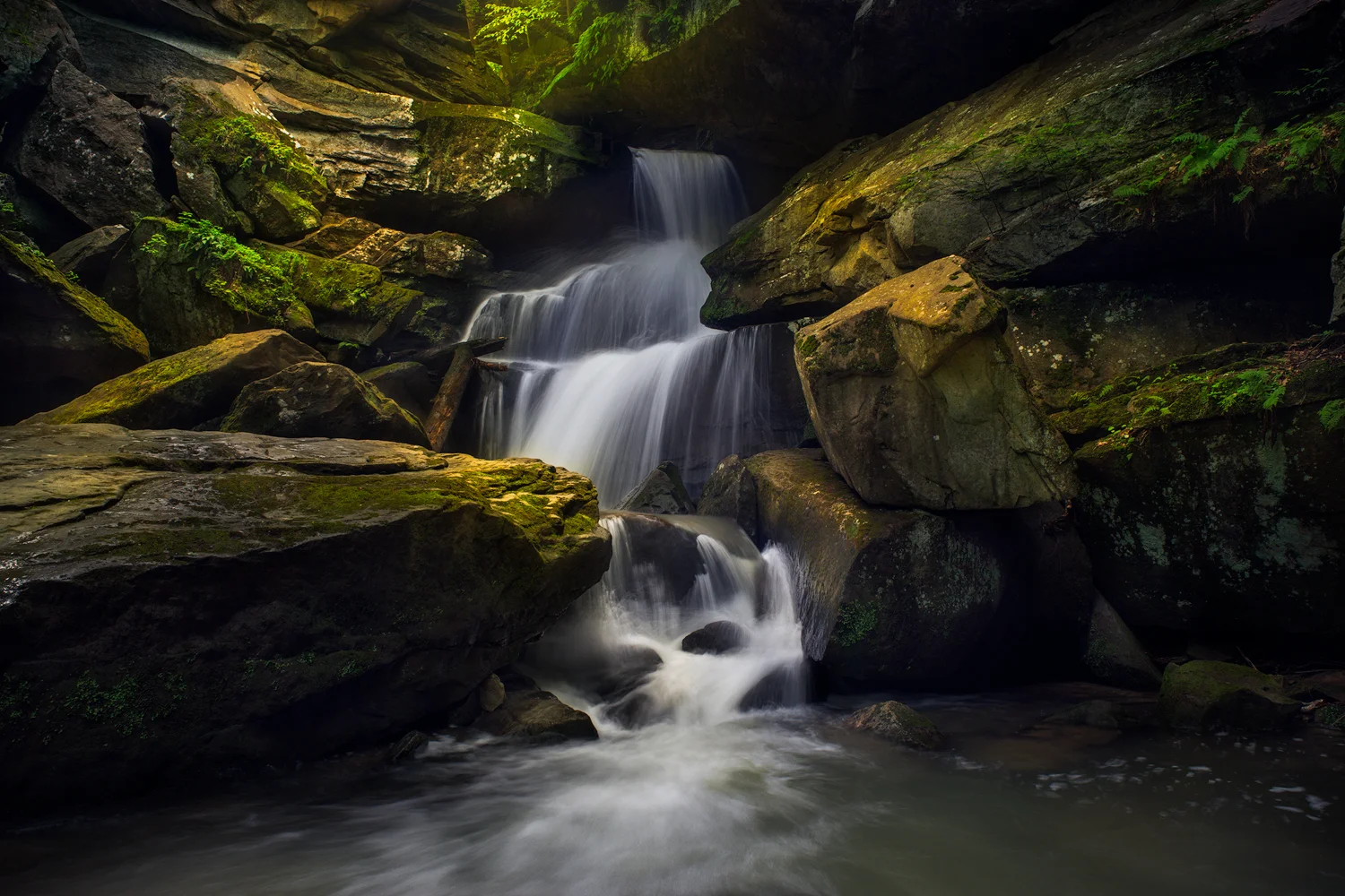 Upper Breakneck Falls flows down through a stair step of cascades to a small plunge pool.