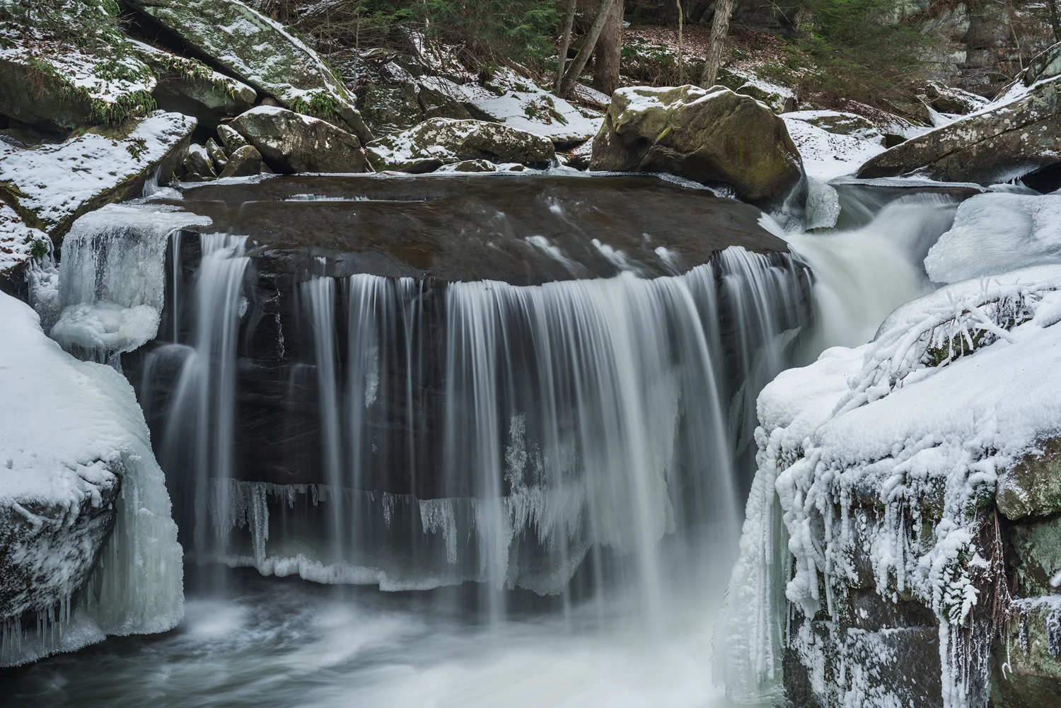A subtle flow along Muddy Creek, Slippery Rock, Pennsylvania, creates a beautiful, veil-like waterfall over a plinth of stone. Capture time: 1 Second