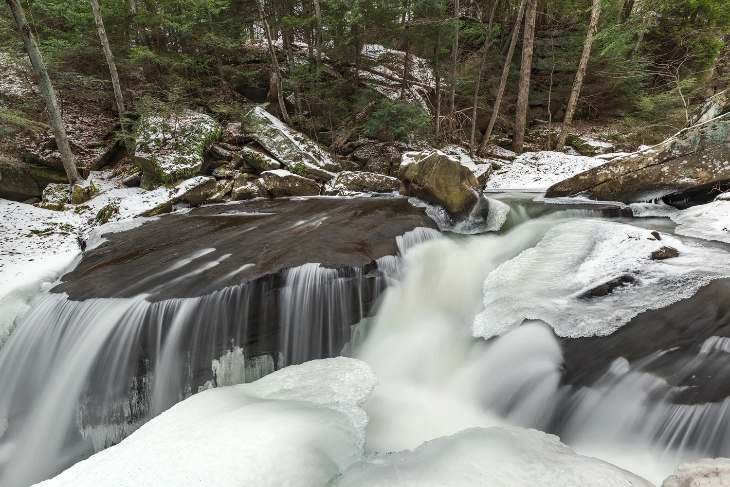 The Lower Falls of Muddy Creek flows over a large shelf of Homewood Sandstone. Powerful hydraulics are formed by a narrow slot just to the right of the main shelf.
