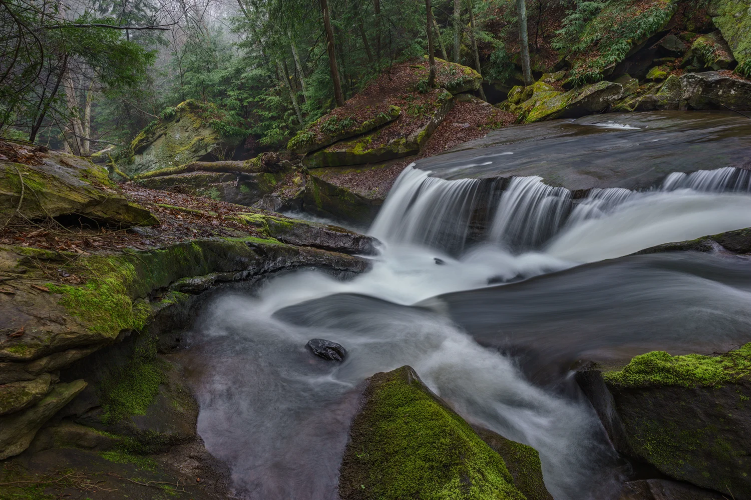 The sweeping forms of the rocks force the creek into a narrow slot and over a hanging sandstone shelf. Shot with a Sony a7II and a Zeiss Loxia 21mm, f2.8. Image exposed at ISO 50, at f11 for 3.0 seconds.